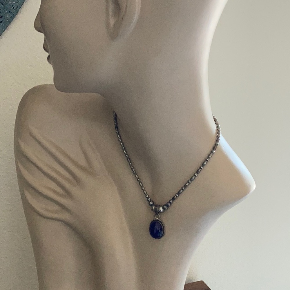 Artist made silver beaded necklace.